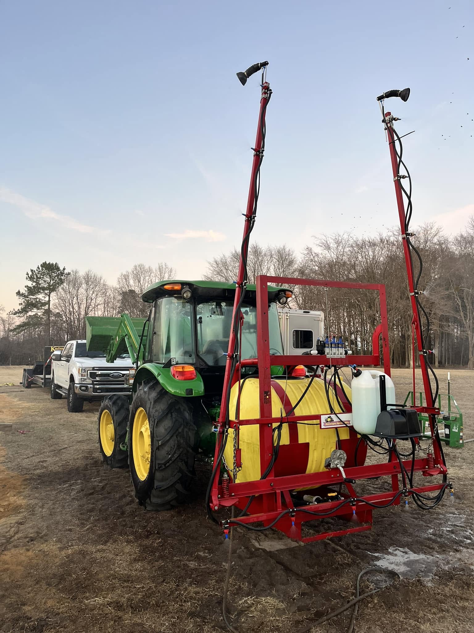 Tractor fitted with a pasture spraying attachment